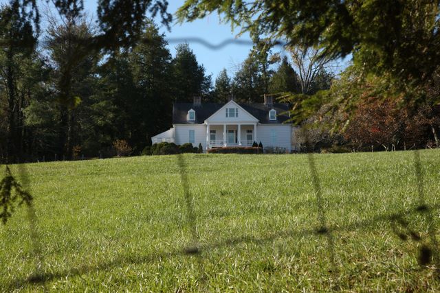 Unique view of home through a fence