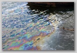 Oil slick visible on water's surface above the sunken battleship USS Arizona 